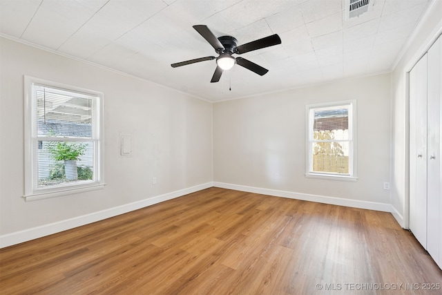202 W Burnham Ave, Sapulpa, OK 74066 - unfurnished bedroom with multiple windows, ornamental molding, light wood-type flooring, and a ceiling fan