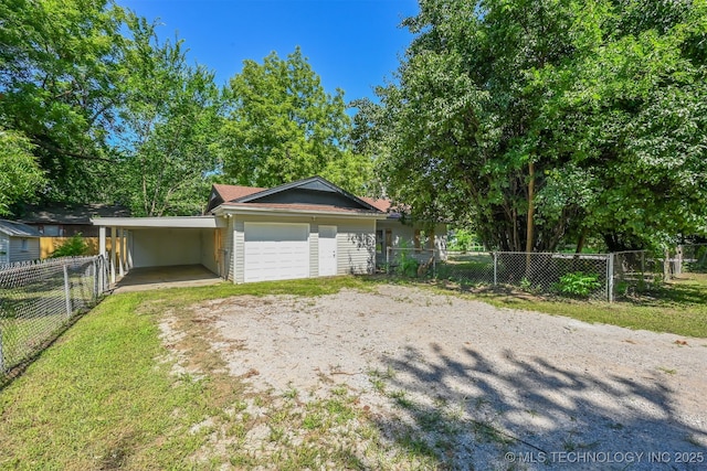 202 W Burnham Ave, Sapulpa, OK 74066 - garage featuring driveway and an attached carport