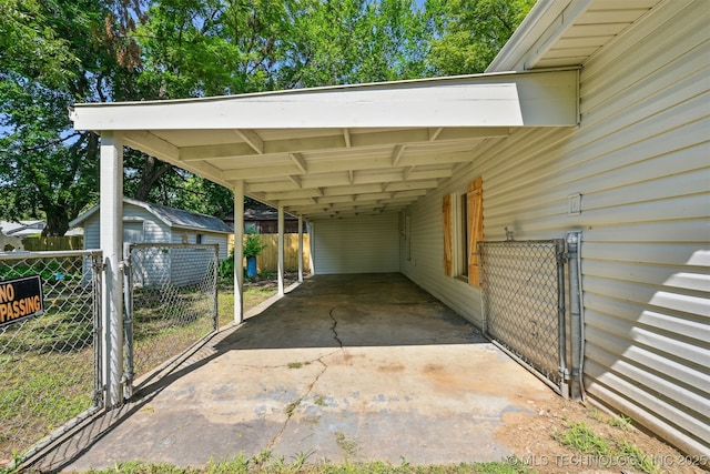 202 W Burnham Ave, Sapulpa, OK 74066 - view of vehicle parking featuring a carport, a gate, and a shed