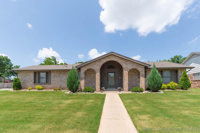 606 N Gum St, Jenks, OK 74037 - view of front facade with brick siding, a front lawn, and roof with shingles