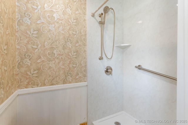 606 N Gum St, Jenks, OK 74037 - bathroom featuring wallpapered walls, a shower, and a wainscoted wall
