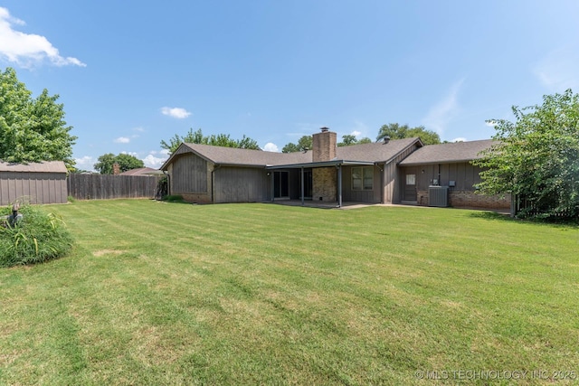 606 N Gum St, Jenks, OK 74037 - rear view of house featuring a chimney and a patio