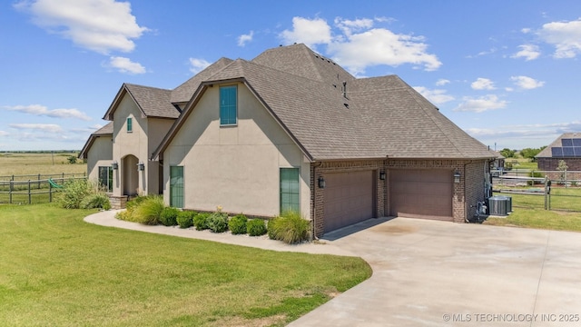 6107 E 127th St N, Collinsville, OK 74021 - view of home's exterior with concrete driveway, an attached garage, stucco siding, a shingled roof, and brick siding