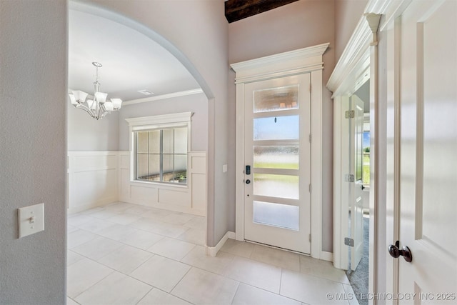 6107 E 127th St N, Collinsville, OK 74021 - entryway featuring arched walkways, plenty of natural light, a chandelier, light tile patterned flooring, and ornamental molding