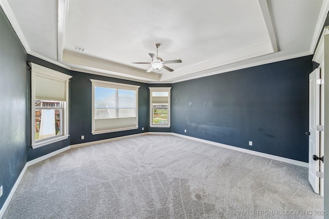 6107 E 127th St N, Collinsville, OK 74021 - spare room featuring a tray ceiling, crown molding, a ceiling fan, and carpet floors