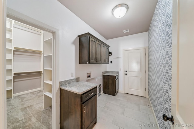 6107 E 127th St N, Collinsville, OK 74021 - laundry room with cabinet space, wallpapered walls, washer hookup, and light tile patterned flooring