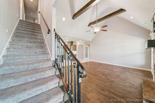 6107 E 127th St N, Collinsville, OK 74021 - staircase with arched walkways, ceiling fan, beamed ceiling, high vaulted ceiling, and wood finished floors