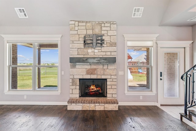 6107 E 127th St N, Collinsville, OK 74021 - unfurnished living room featuring hardwood / wood-style floors and a fireplace