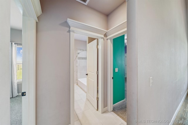 6107 E 127th St N, Collinsville, OK 74021 - hallway with light tile patterned flooring and baseboards