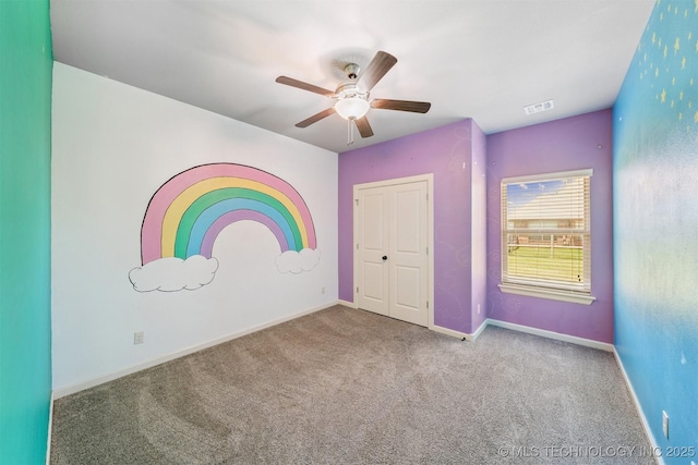 6107 E 127th St N, Collinsville, OK 74021 - unfurnished bedroom featuring carpet, a ceiling fan, and a closet