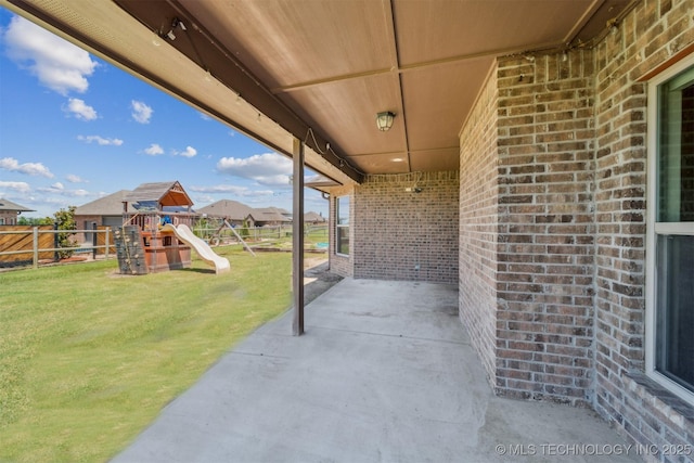 6107 E 127th St N, Collinsville, OK 74021 - fenced backyard with a playground and a patio