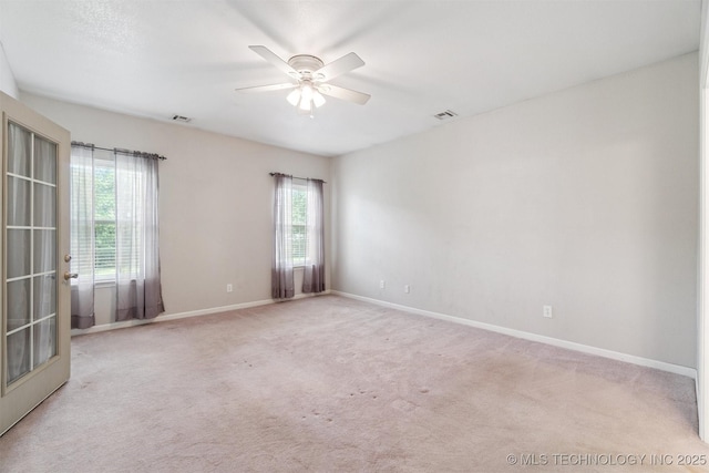 1701 N Skinner Ave, Drumright, OK 74030 - empty room with healthy amount of natural light, a ceiling fan, and carpet