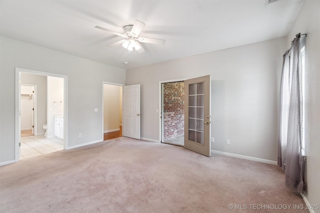 1701 N Skinner Ave, Drumright, OK 74030 - unfurnished bedroom featuring carpet, ensuite bathroom, and ceiling fan