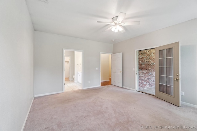 1701 N Skinner Ave, Drumright, OK 74030 - unfurnished bedroom with carpet, connected bathroom, and a ceiling fan