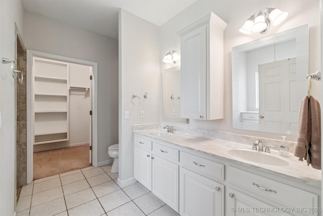 1701 N Skinner Ave, Drumright, OK 74030 - full bath featuring double vanity, tile patterned flooring, and a walk in closet