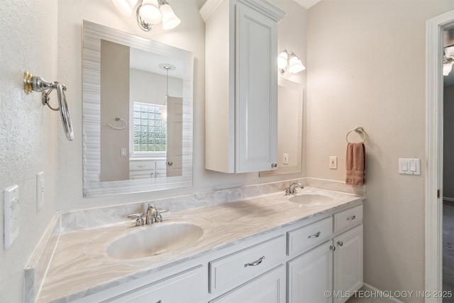1701 N Skinner Ave, Drumright, OK 74030 - bathroom featuring double vanity and a textured wall