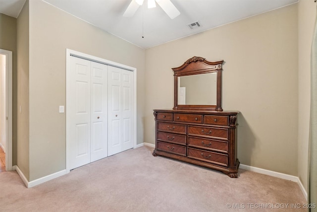 1701 N Skinner Ave, Drumright, OK 74030 - bedroom with light colored carpet, a closet, and ceiling fan