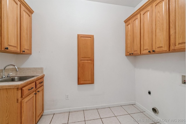 1701 N Skinner Ave, Drumright, OK 74030 - laundry room featuring cabinet space, washer hookup, hookup for an electric dryer, and light tile patterned flooring