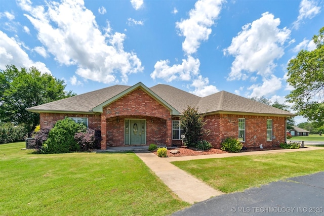 1701 N Skinner Ave, Drumright, OK 74030 - single story home with brick siding, roof with shingles, and a front yard