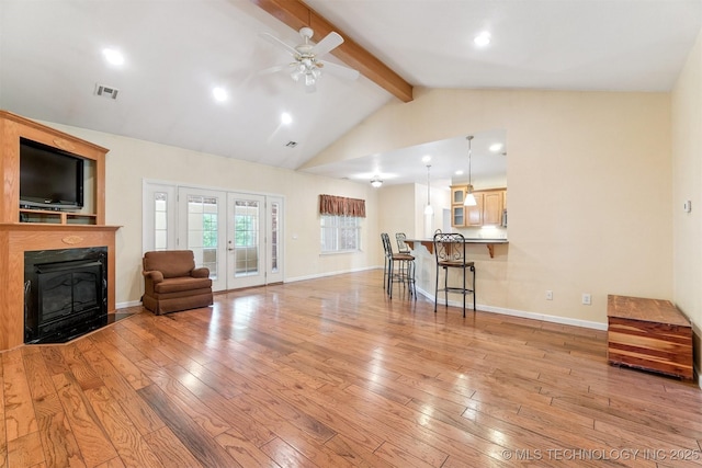 1701 N Skinner Ave, Drumright, OK 74030 - living room with light wood-style flooring, a ceiling fan, a fireplace with flush hearth, recessed lighting, and french doors