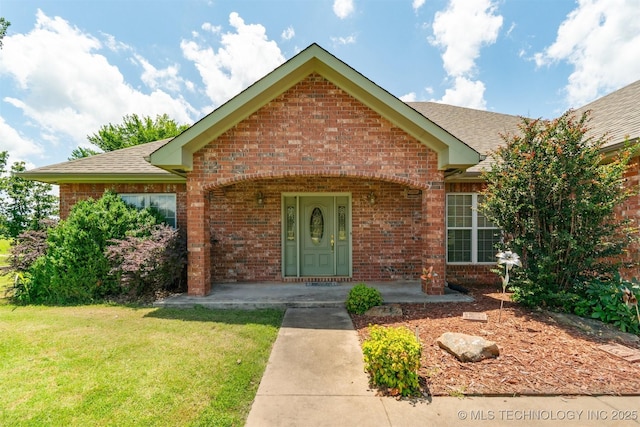 1701 N Skinner Ave, Drumright, OK 74030 - ranch-style home with brick siding, a front yard, and roof with shingles