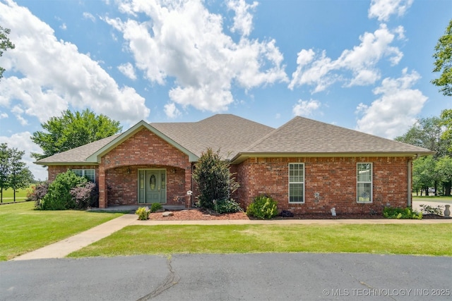 1701 N Skinner Ave, Drumright, OK 74030 - single story home featuring brick siding, a front yard, and roof with shingles