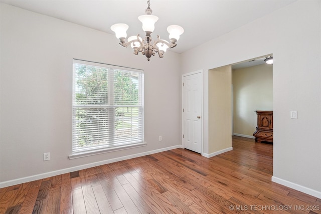1701 N Skinner Ave, Drumright, OK 74030 - spare room featuring a chandelier and hardwood / wood-style floors