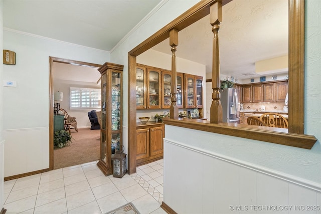 1605 N Skinner Ave, Drumright, OK 74030 - hallway with light tile patterned floors, light carpet, and ornamental molding
