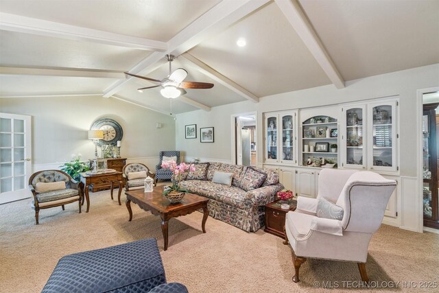 1605 N Skinner Ave, Drumright, OK 74030 - living area featuring light carpet, a ceiling fan, and a wainscoted wall