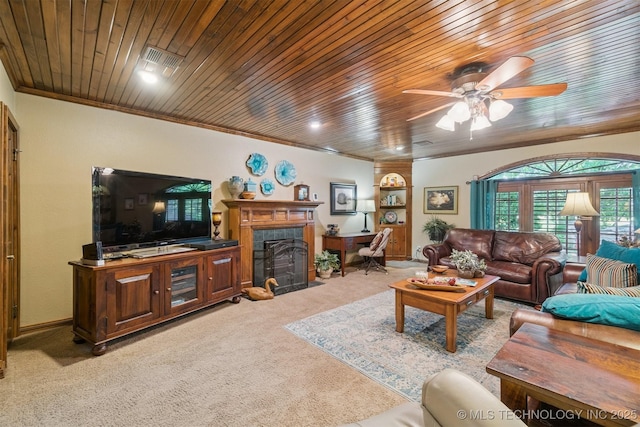 1605 N Skinner Ave, Drumright, OK 74030 - living area with light colored carpet, wooden ceiling, a fireplace with flush hearth, ceiling fan, and ornamental molding