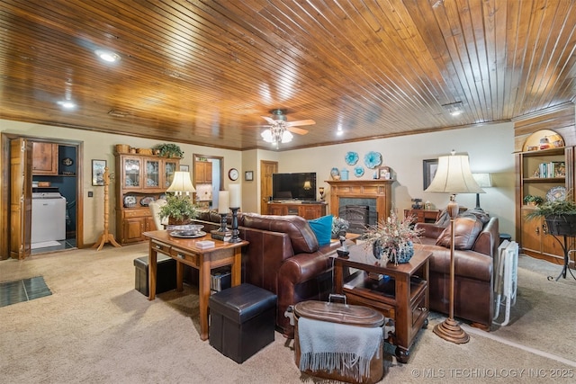 1605 N Skinner Ave, Drumright, OK 74030 - living area featuring light colored carpet, wood ceiling, washer / dryer, a ceiling fan, and a premium fireplace