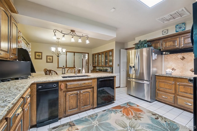 1605 N Skinner Ave, Drumright, OK 74030 - kitchen featuring stainless steel fridge with ice dispenser, black dishwasher, tasteful backsplash, a peninsula, and light tile patterned floors
