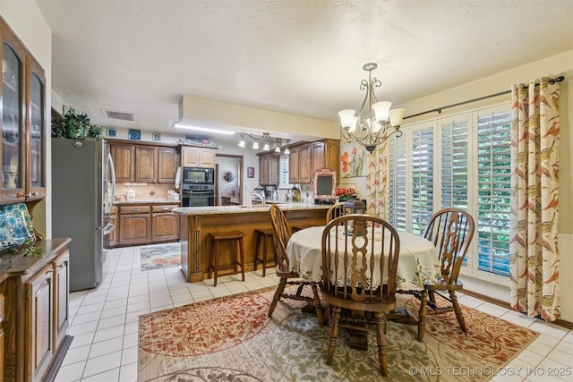 1605 N Skinner Ave, Drumright, OK 74030 - dining room featuring a chandelier and light tile patterned flooring