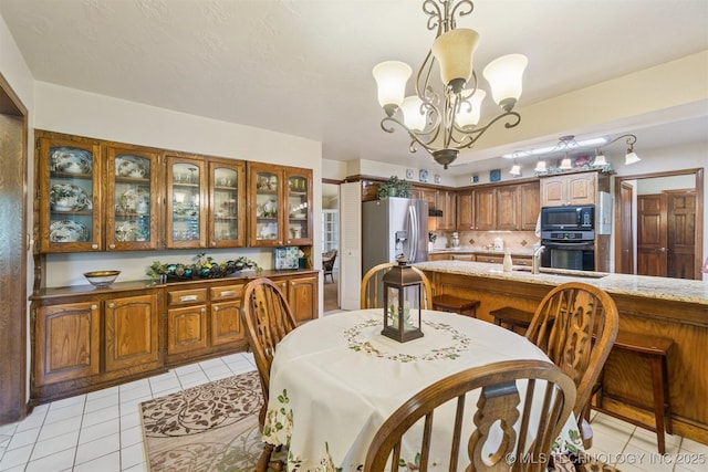 1605 N Skinner Ave, Drumright, OK 74030 - dining space with light tile patterned flooring and a chandelier