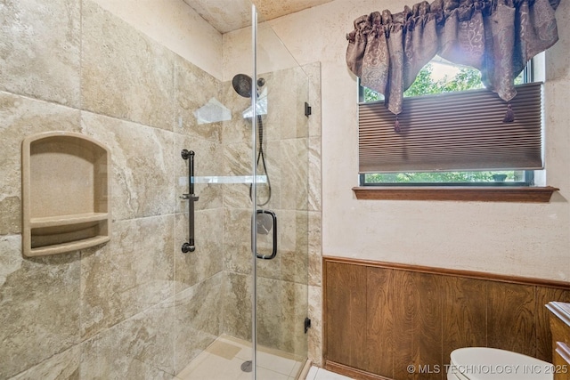 1605 N Skinner Ave, Drumright, OK 74030 - full bath featuring a stall shower, healthy amount of natural light, and wainscoting
