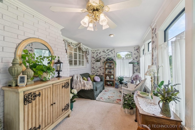 1605 N Skinner Ave, Drumright, OK 74030 - living area with carpet floors, ceiling fan, ornamental molding, and brick wall
