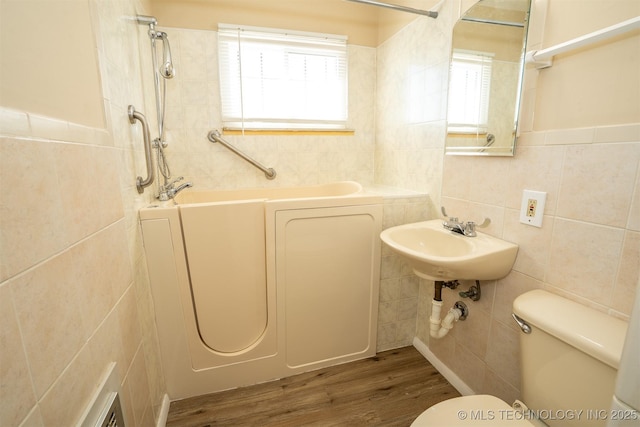 1504 E 51st St, Tulsa, OK 74126 - bathroom with tile walls, a bathtub, a shower, and wood finished floors
