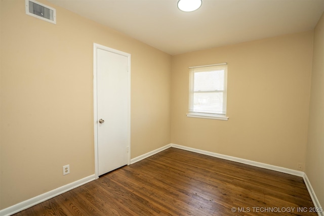 1504 E 51st St, Tulsa, OK 74126 - unfurnished room featuring baseboards and dark wood finished floors