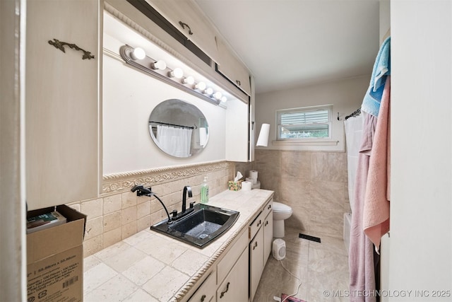 5105 E 30th Pl, Tulsa, OK 74114 - full bathroom with vanity, a shower with shower curtain, tile walls, and a wainscoted wall