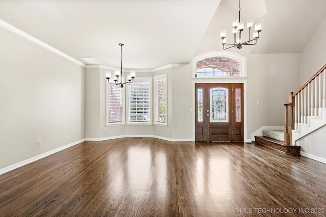 4207 S 69th W Ave, Tulsa, OK 74107 - foyer entrance with a chandelier, stairway, dark wood-style flooring, a high ceiling, and ornamental molding