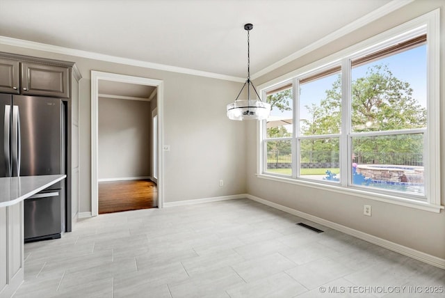 4207 S 69th W Ave, Tulsa, OK 74107 - unfurnished dining area featuring a chandelier and ornamental molding