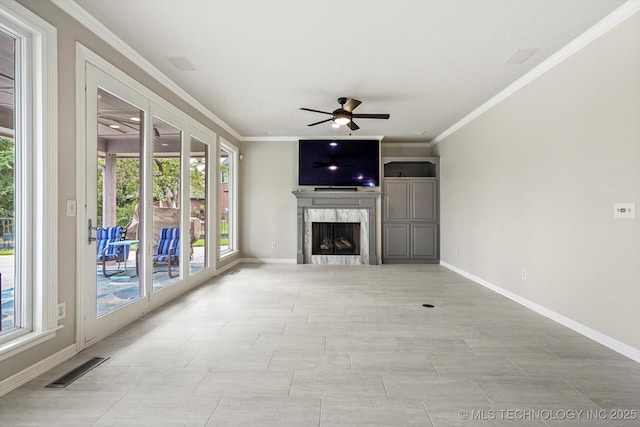 4207 S 69th W Ave, Tulsa, OK 74107 - unfurnished living room featuring a ceiling fan, crown molding, a fireplace, and healthy amount of natural light