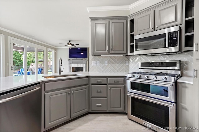 4207 S 69th W Ave, Tulsa, OK 74107 - kitchen featuring gray cabinets, stainless steel appliances, crown molding, ceiling fan, and light countertops