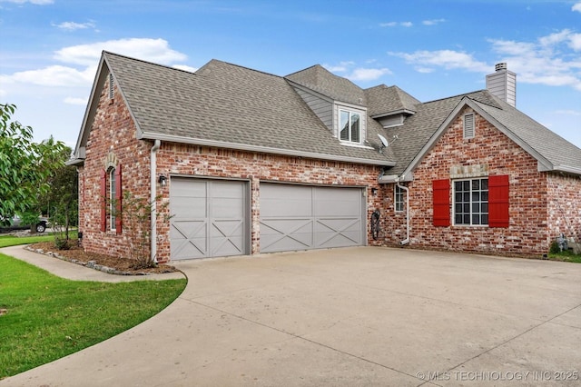 4207 S 69th W Ave, Tulsa, OK 74107 - view of front of property featuring roof with shingles, concrete driveway, brick siding, and a garage