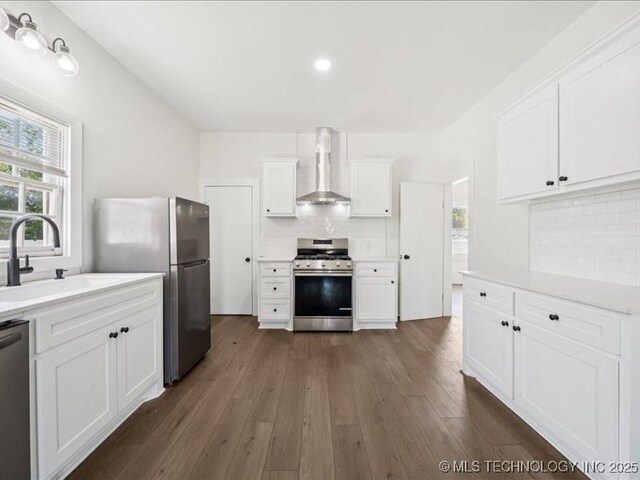 402 E Patti Page Blvd, Claremore, OK 74017 - kitchen featuring stainless steel appliances, wall chimney range hood, tasteful backsplash, light countertops, and recessed lighting