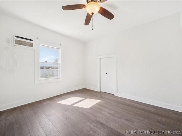 402 E Patti Page Blvd, Claremore, OK 74017 - empty room featuring a wall mounted air conditioner, wood finished floors, and a ceiling fan