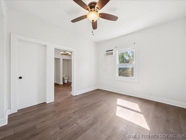 402 E Patti Page Blvd, Claremore, OK 74017 - unfurnished bedroom with a chandelier, a wall unit AC, wood finished floors, and ceiling fan