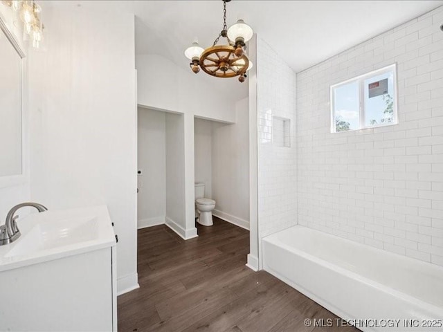 402 E Patti Page Blvd, Claremore, OK 74017 - full bath with a chandelier, wood finished floors, vanity, bathtub / shower combination, and vaulted ceiling