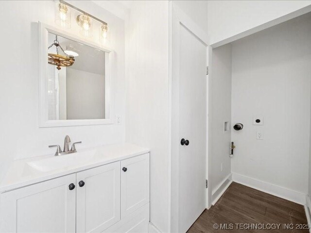 402 E Patti Page Blvd, Claremore, OK 74017 - washroom with electric dryer hookup and dark wood finished floors