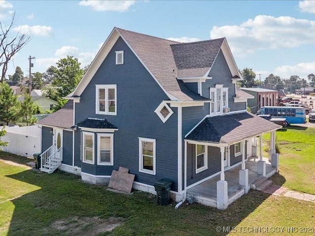 402 E Patti Page Blvd, Claremore, OK 74017 - rear view of house with a yard, entry steps, and a shingled roof
